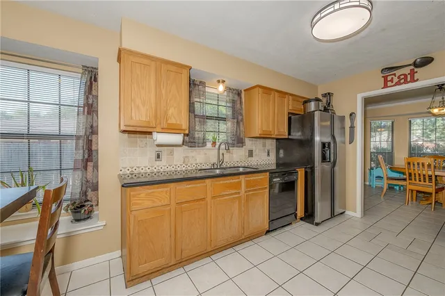 a kitchen with stainless steel appliances granite countertop a sink and cabinets