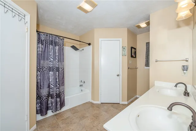 a bathroom with a bathtub and shower