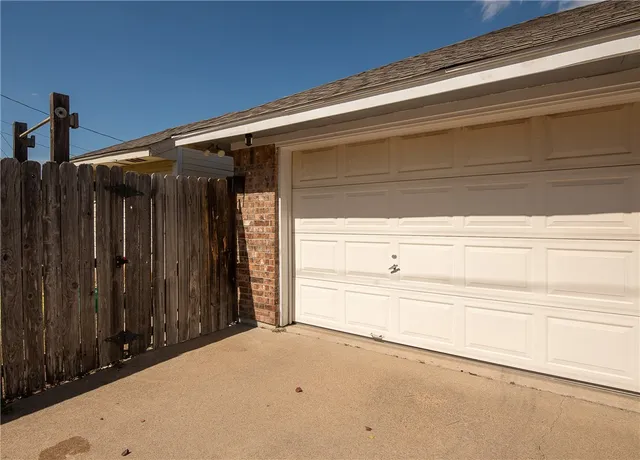 a view of a house with a yard and garage