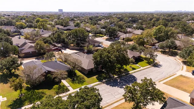 an aerial view of residential houses with outdoor space