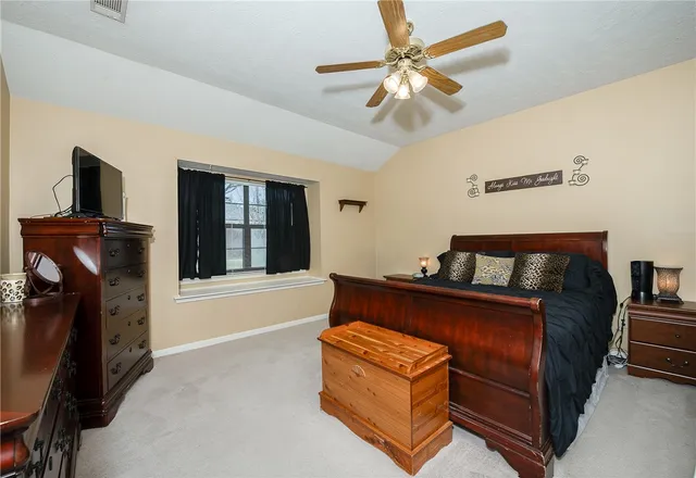 a bed room with a bed and a television