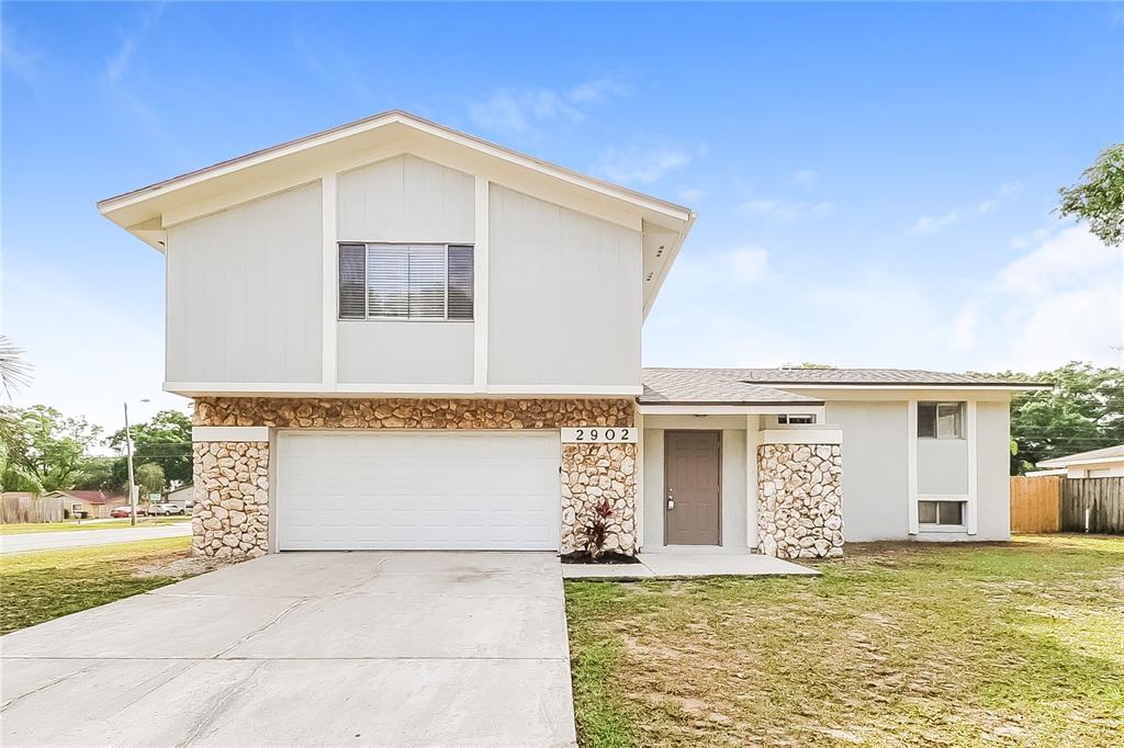 2902 Ripplewood Drive Seffner, FL 33584 - Photo 1 of 18 a front view of a house with a yard
