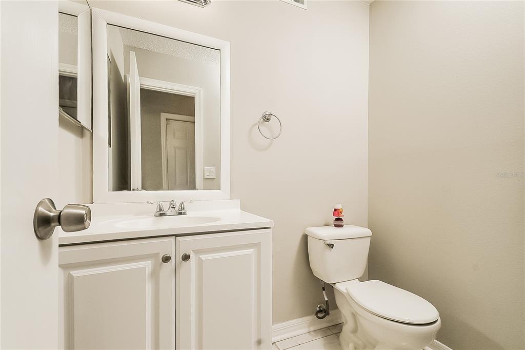 2902 Ripplewood Drive Seffner, FL 33584 - Photo 14 of 18 a bathroom with a toilet sink and mirror