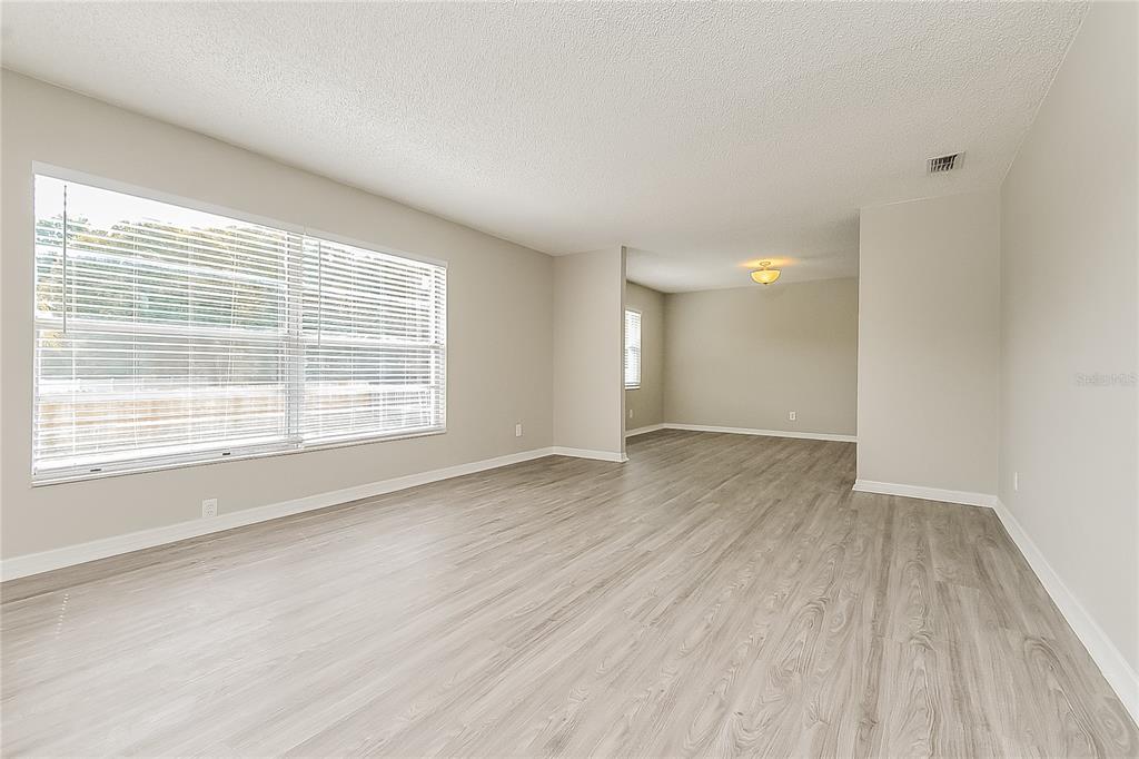 2902 Ripplewood Drive Seffner, FL 33584 - Photo 2 of 18 an empty room with wooden floor and windows