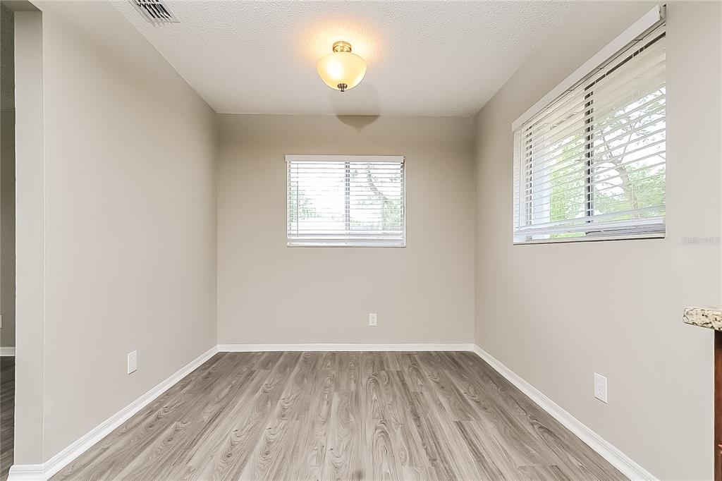 2902 Ripplewood Drive Seffner, FL 33584 - Photo 5 of 18 an empty room with wooden floor and windows