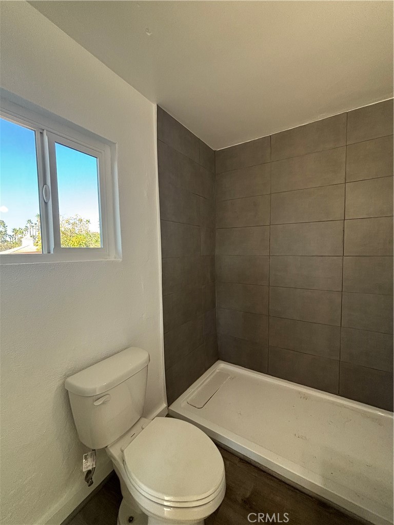 15360 Washington Street Riverside, CA 92506 - Photo 11 of 14 a white toilet and a shower in a bathroom