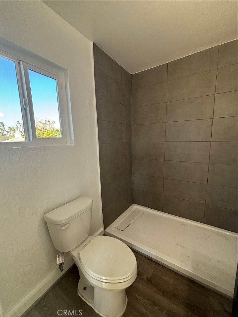 15360 Washington Street Riverside, CA 92506 - Photo 12 of 14 a white toilet sitting next to a bathroom sink and a window