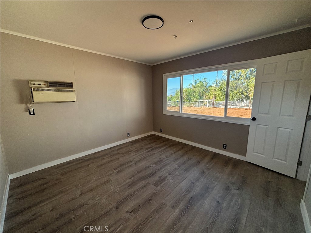 15360 Washington Street Riverside, CA 92506 - Photo 6 of 14 a view of an empty room with wooden floor and a window