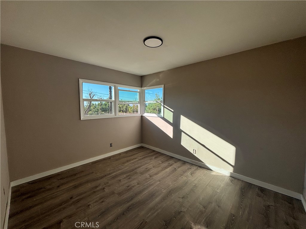 15360 Washington Street Riverside, CA 92506 - Photo 9 of 14 a view of an empty room with wooden floor and a window