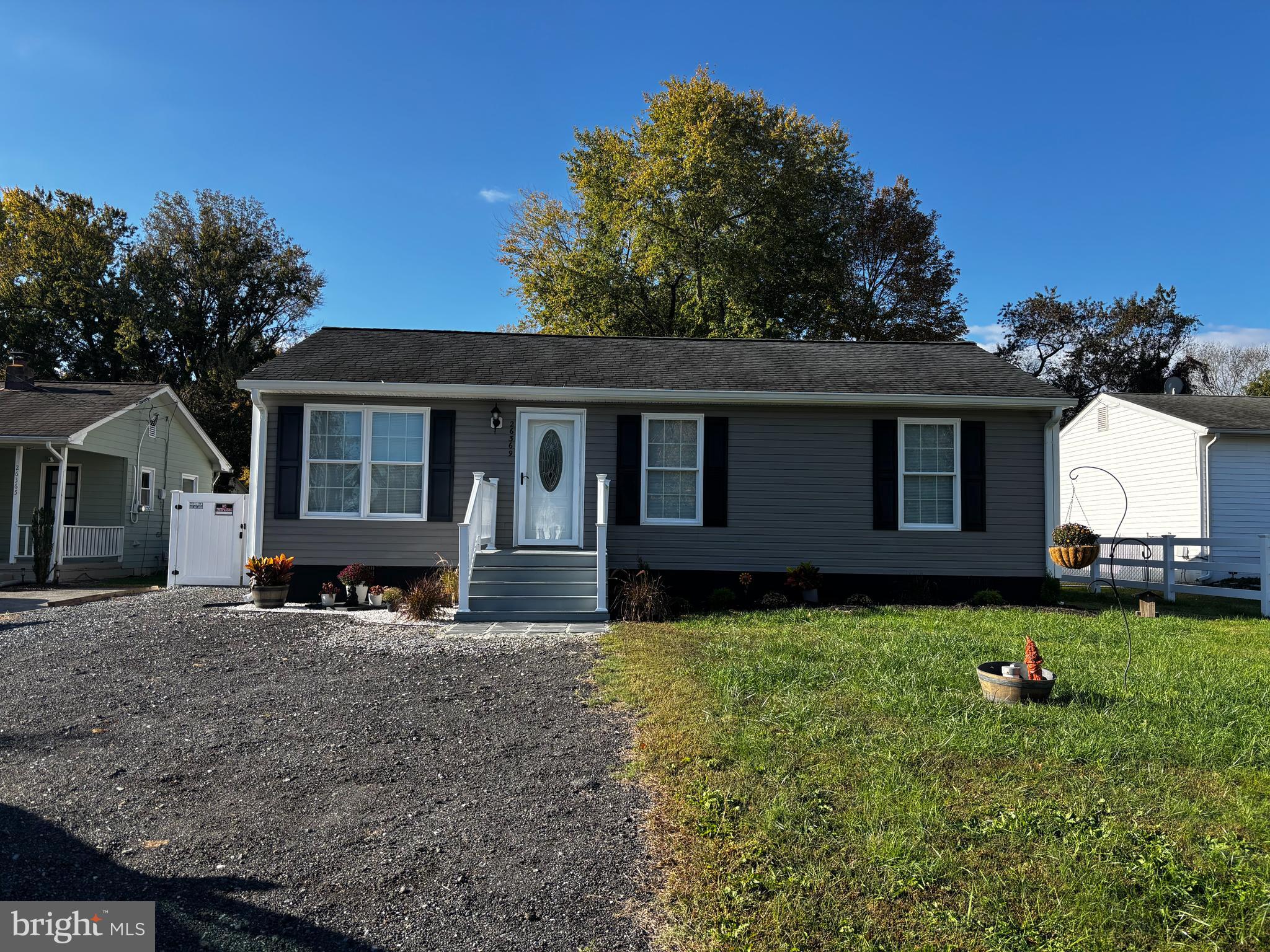 a house that has a big yard with wooden fence