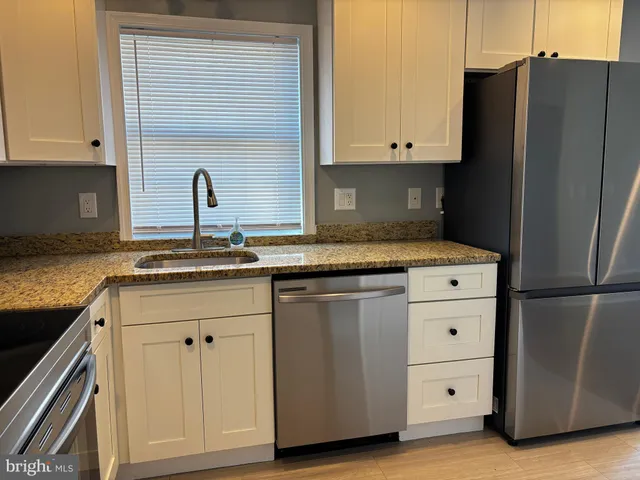 a kitchen with appliances cabinets and a counter top space