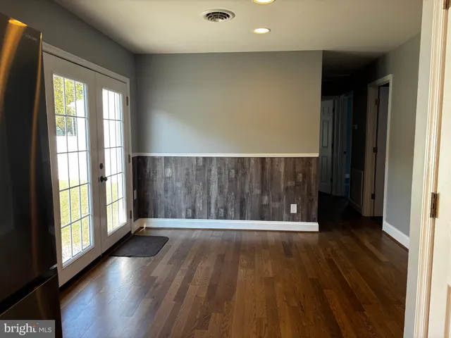 a view of wooden floor with brick walls