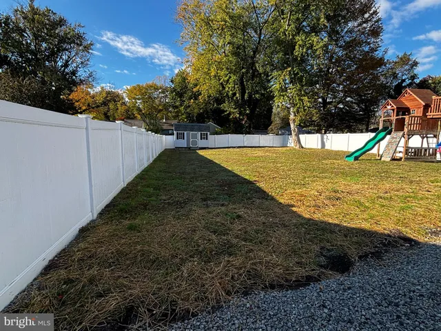 a view of a backyard with swimming pool