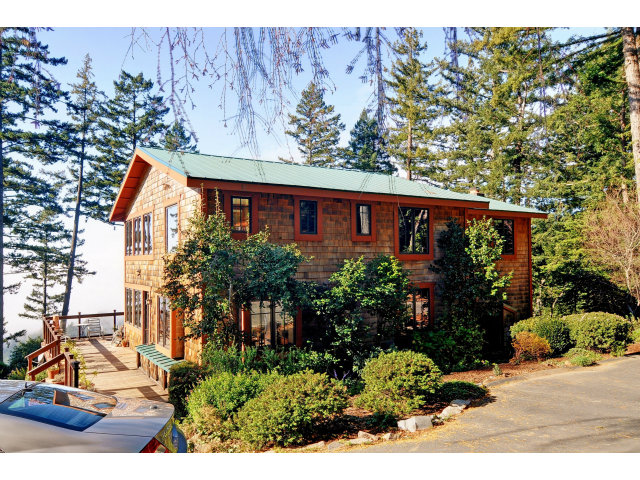 220 Ware Road Woodside, CA 94062 - Photo 2 of 19 a view of a house with a tree and flower plants