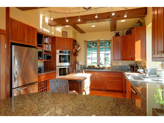 220 Ware Road Woodside, CA 94062 - Photo 9 of 19 a kitchen with stainless steel appliances granite countertop a refrigerator a sink dishwasher a dining table and chairs with wooden floor