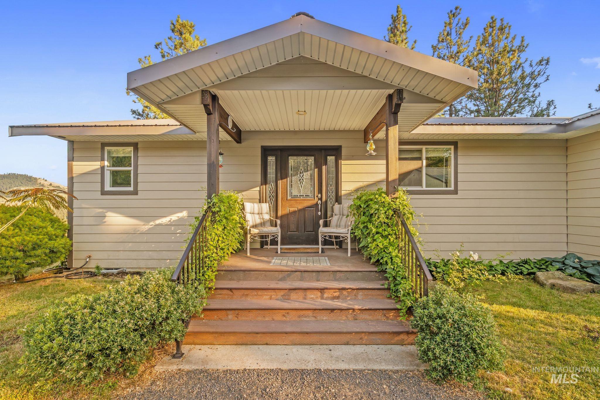 435 River Pointe Lane Lenore, ID 83541 - Photo 6 of 50 Covered front porch featuring wood-finish steps and decorative railings