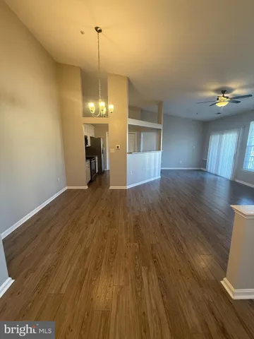 a kitchen with granite countertop wooden cabinets a stove and stainless steel appliances