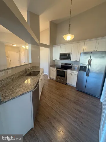 a view of granite countertop cabinets and sink