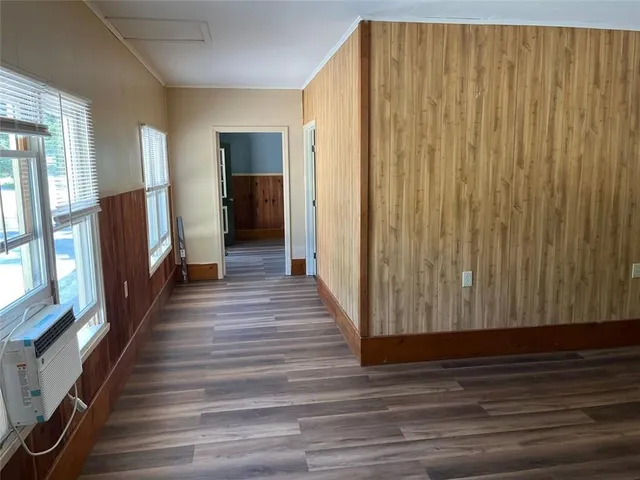 a view of a hallway with wooden floor and staircase