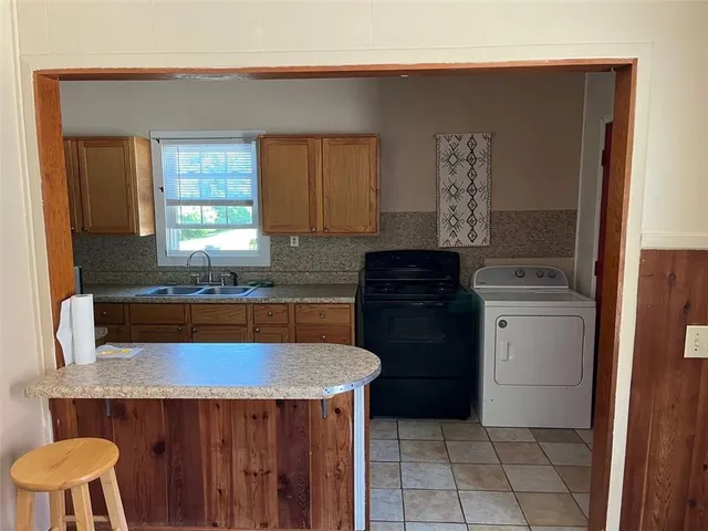 a kitchen with a sink a stove and a refrigerator