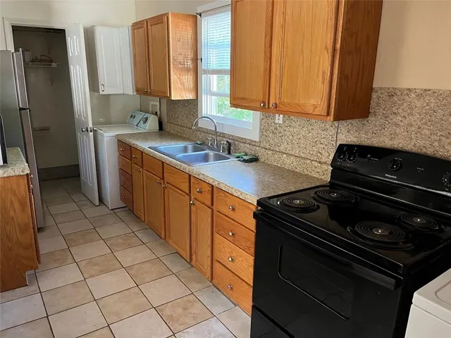 a kitchen with a stove a sink and a microwave