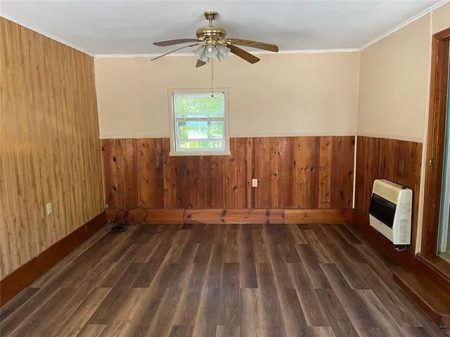 a view of an empty room with a fireplace and a window