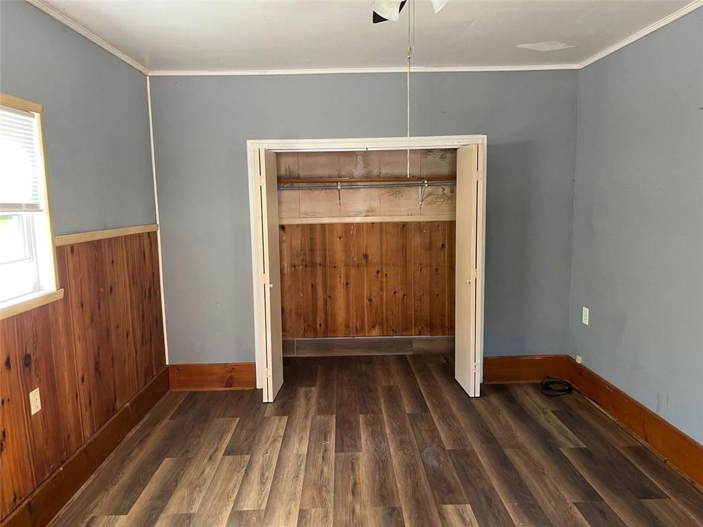 7128 Dawsonville Highway Dawsonville, GA 30534 - Photo 7 of 7 a view of an empty room with wooden floor and a window