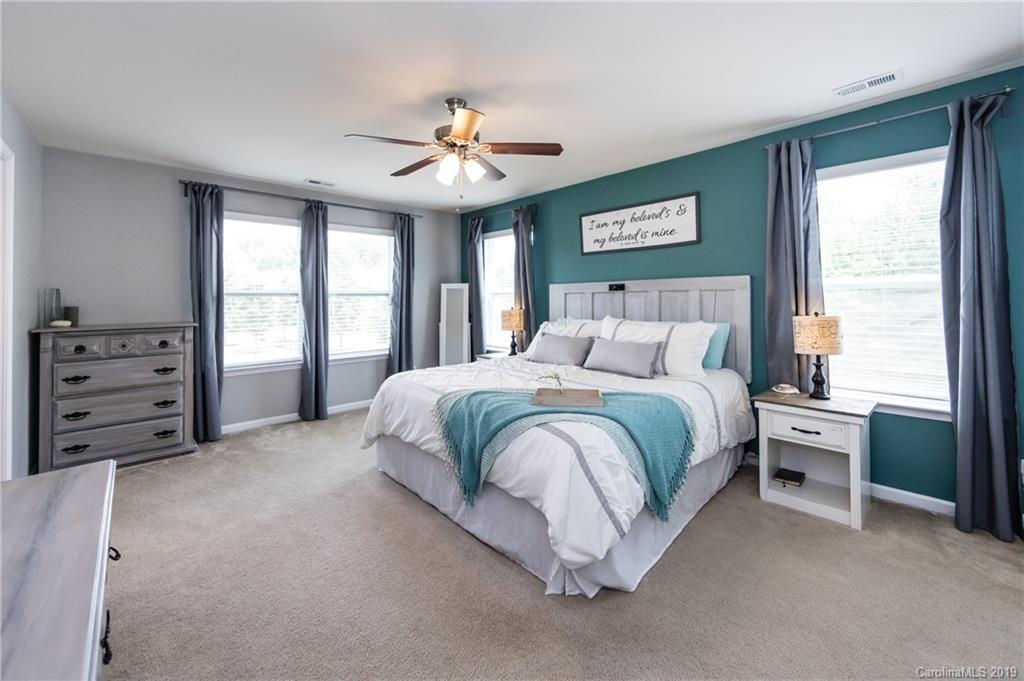 79481 Ridgehaven Road Lancaster, SC 29720 - Photo 21 of 41 a spacious bedroom with a bed and a chandelier