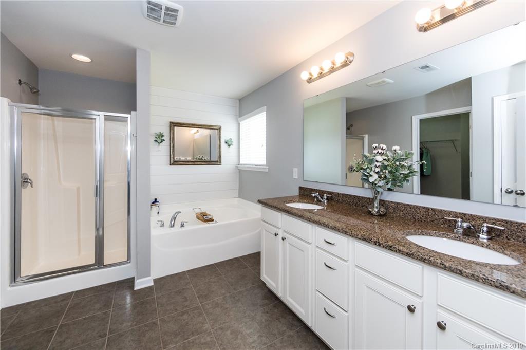 79481 Ridgehaven Road Lancaster, SC 29720 - Photo 22 of 41 a bathroom with a granite countertop tub sink double vanity and mirror