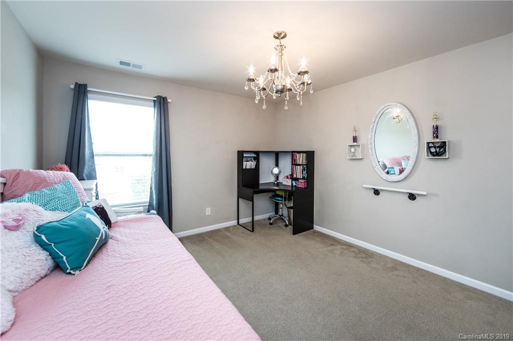 79481 Ridgehaven Road Lancaster, SC 29720 - Photo 29 of 41 a bedroom with a bed and a chandelier