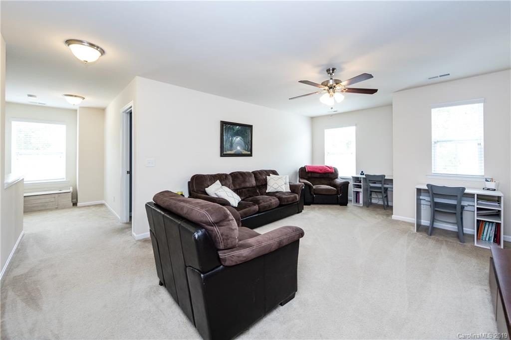 79481 Ridgehaven Road Lancaster, SC 29720 - Photo 33 of 41 a living room with furniture a ceiling fan and a window