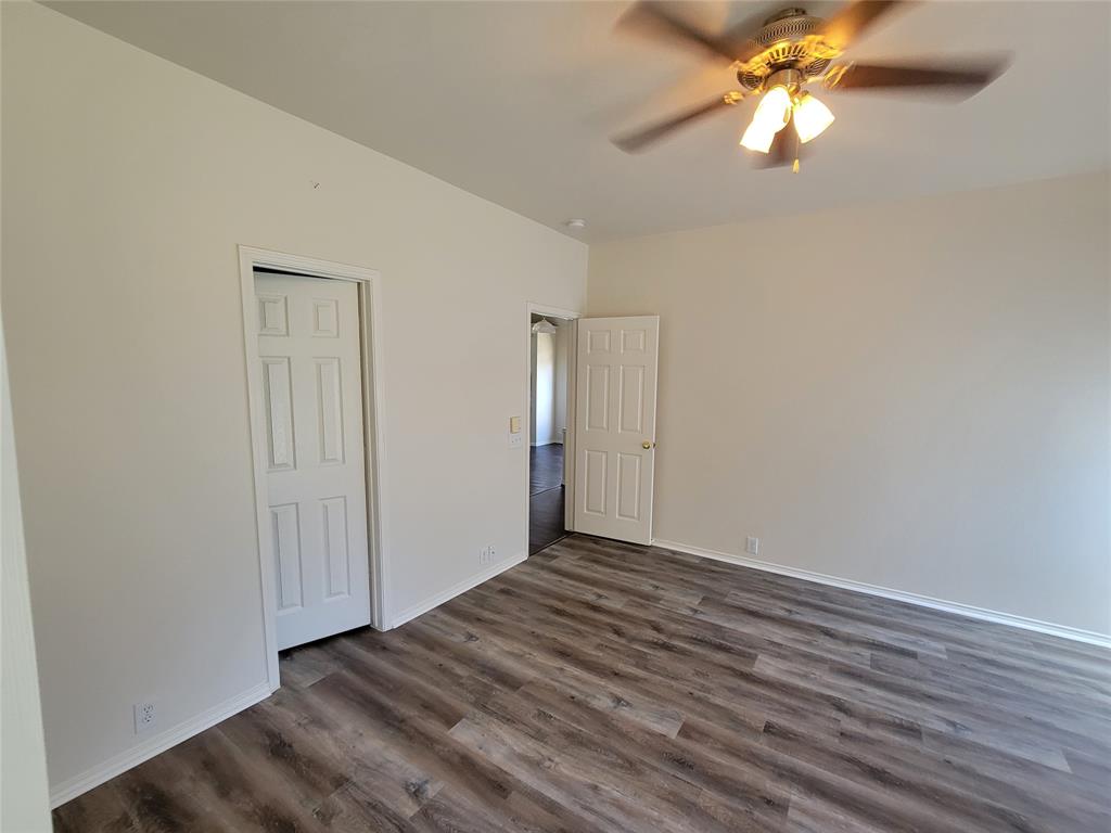 2913 Rush Creek Road McKinney, TX 75072 - Photo 10 of 32 Master with new laminate flooring, large walk-in closet and ceiling fan