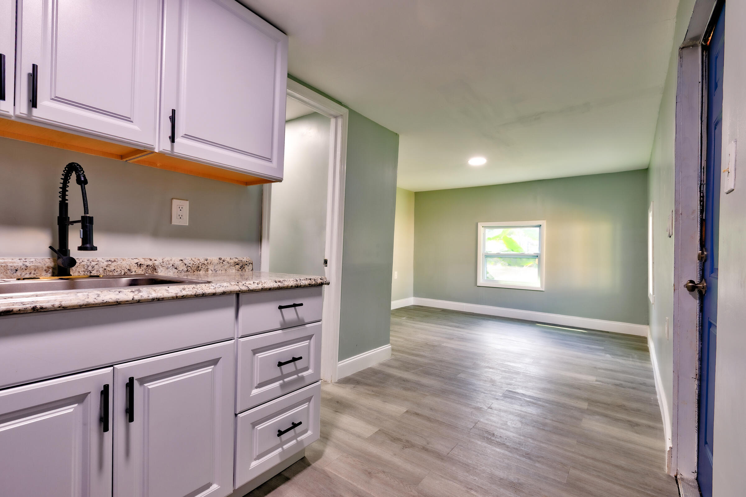 G34 Miriam Street Key West, FL 33040 - Photo 4 of 17 a kitchen with granite countertop white cabinets and white appliances