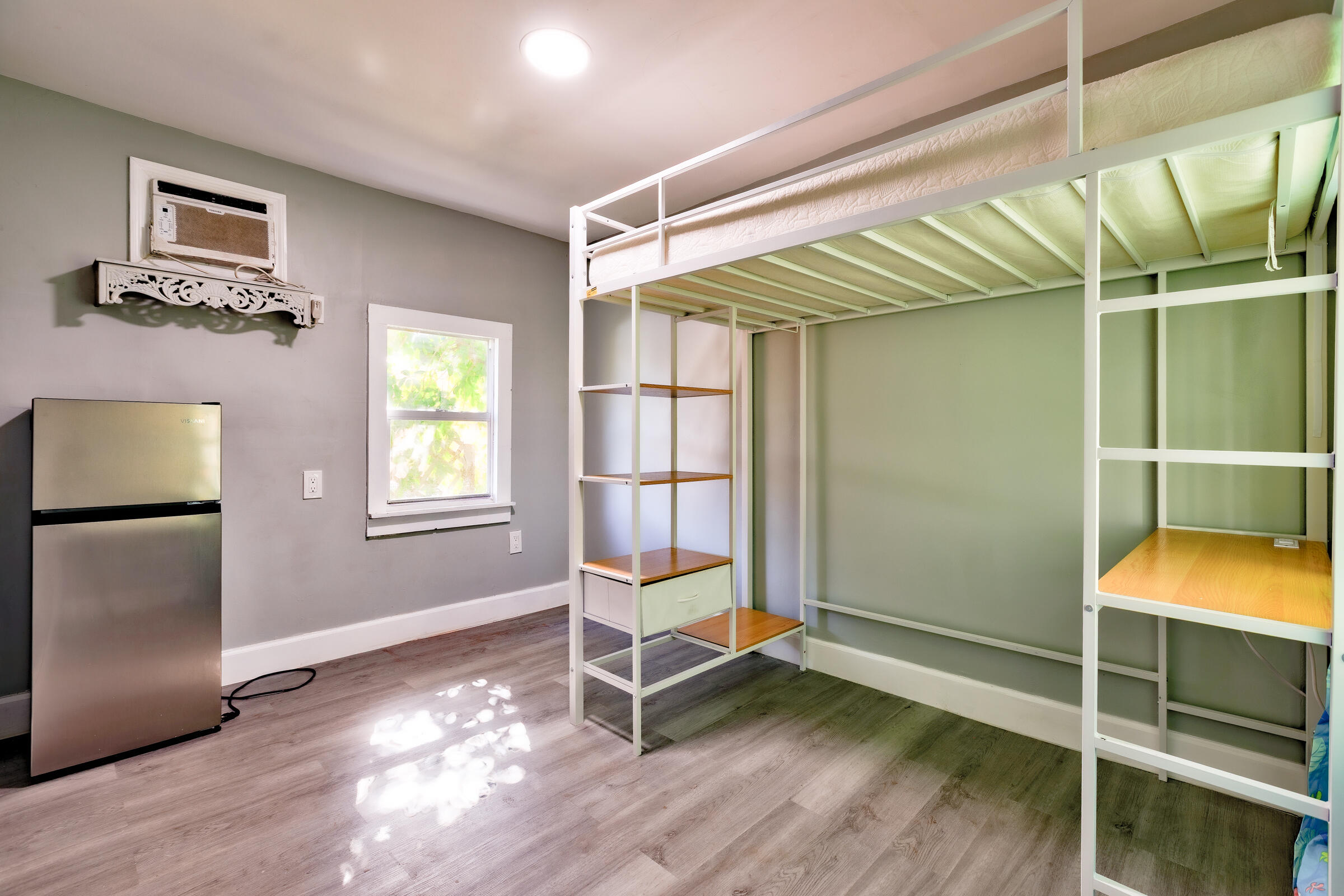 G34 Miriam Street Key West, FL 33040 - Photo 9 of 17 a bedroom with wooden floor and a window