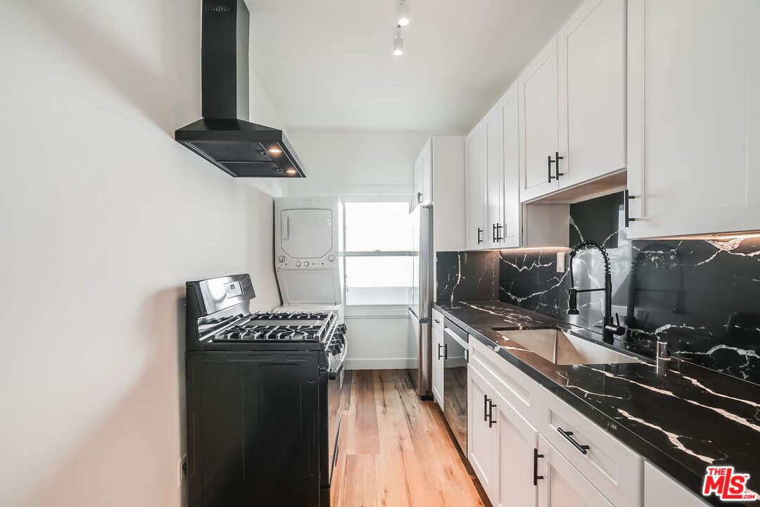 151 North Swall Drive, Unit 4 Beverly Hills, CA 90211 - Photo 12 of 17 a kitchen with a sink stainless steel appliances a counter top space and cabinets