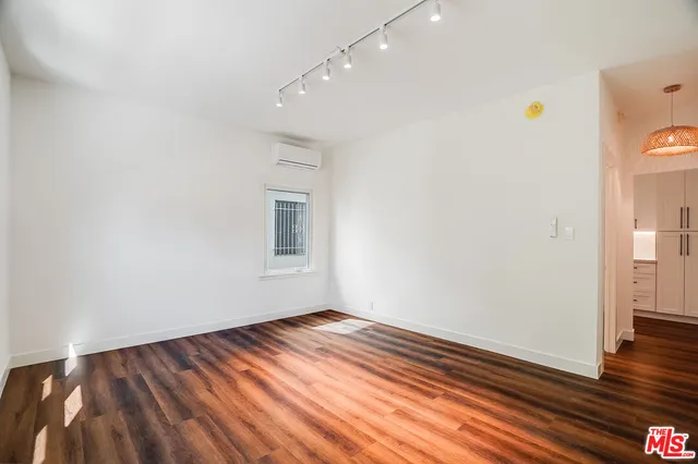 a view of room with wooden floor and fan