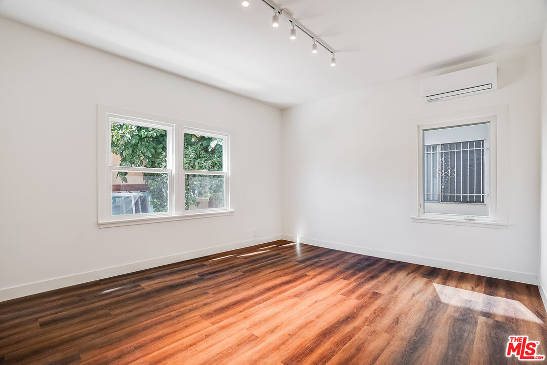 151 North Swall Drive, Unit 4 Beverly Hills, CA 90211 - Photo 3 of 17 a view of an empty room with wooden floor and a window