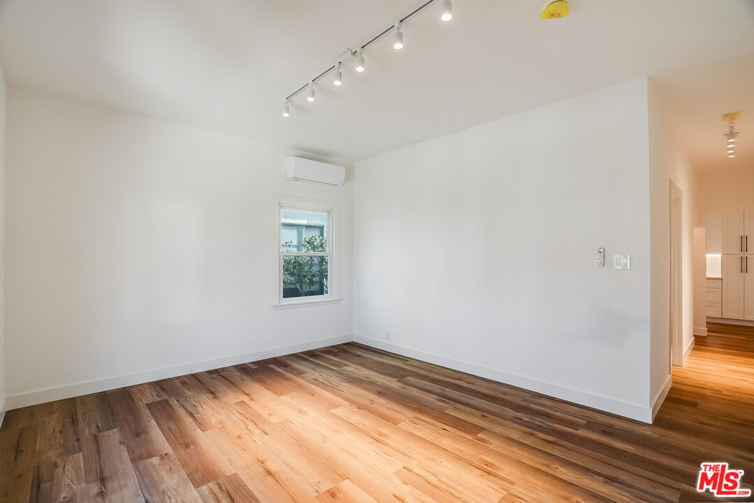 151 North Swall Drive, Unit 4 Beverly Hills, CA 90211 - Photo 4 of 17 a view of empty room with wooden floor and fan
