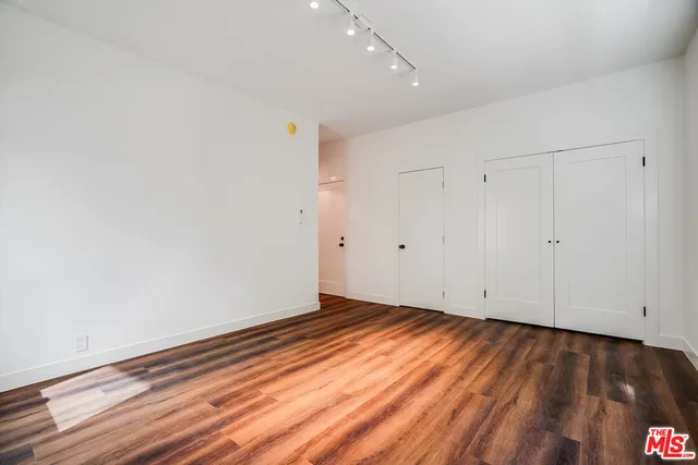a view of room with wooden floor