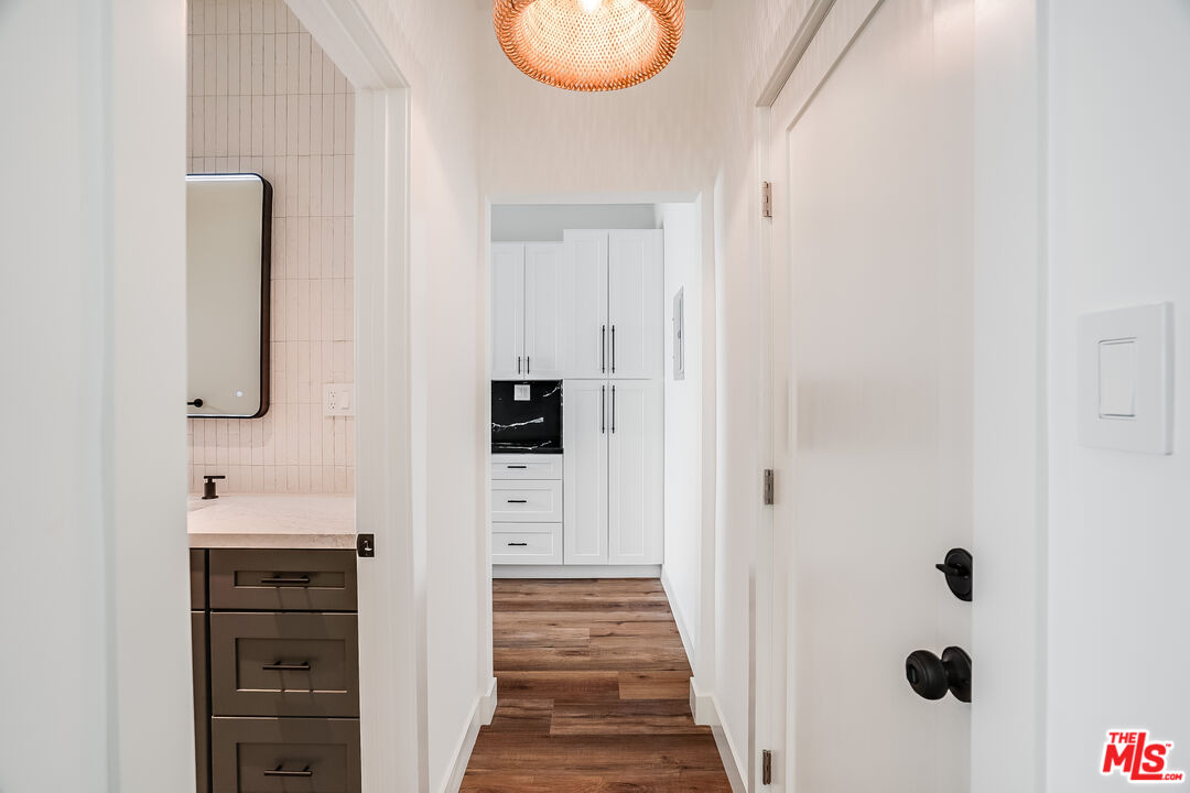 151 North Swall Drive, Unit 4 Beverly Hills, CA 90211 - Photo 7 of 17 a hallway with cabinets and wooden floor