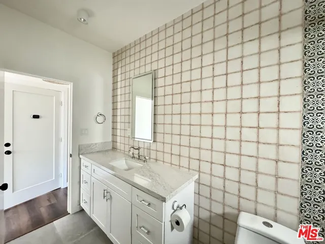 a bathroom with a sink mirror vanity and toilet