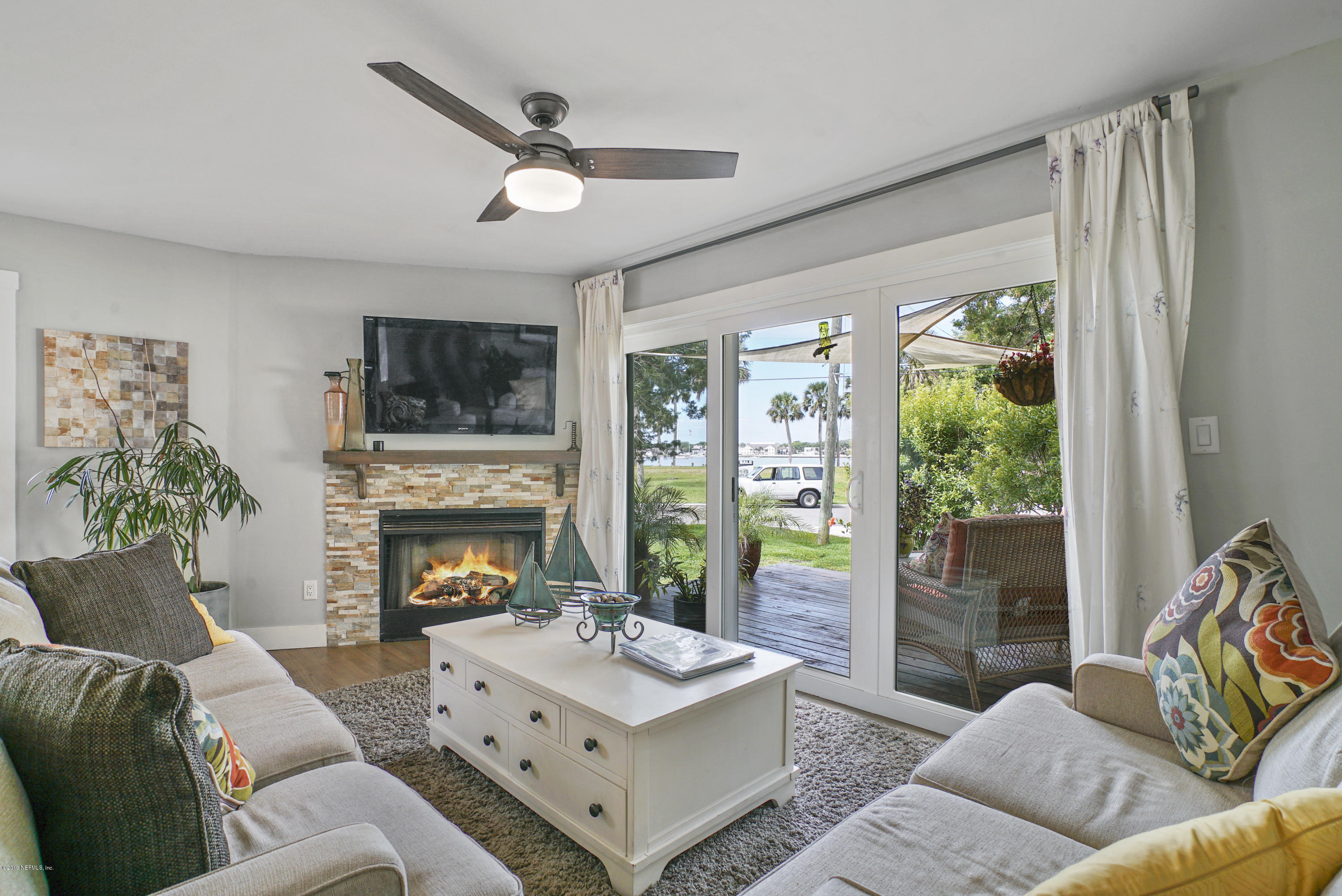 32 Dolphin Drive St. Augustine, FL 32080 - Photo 11 of 43 a living room with furniture and a fireplace