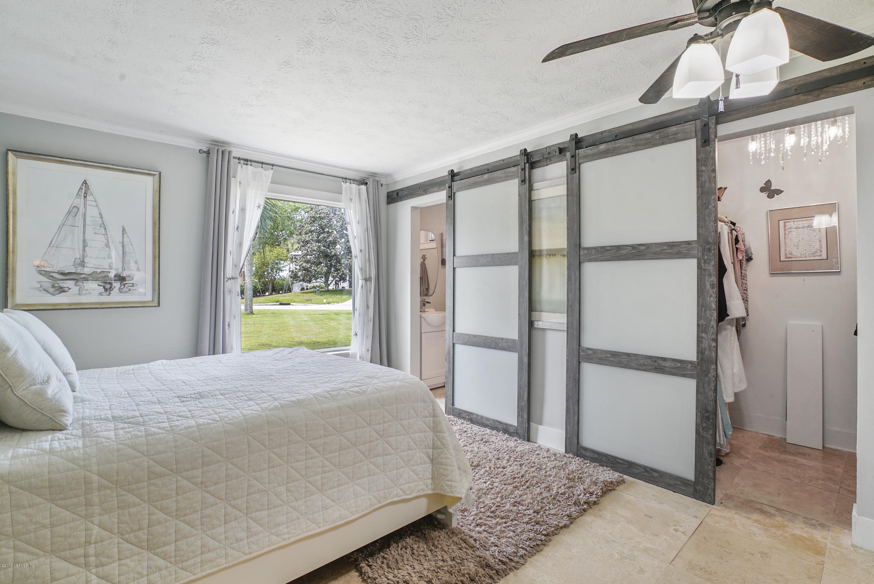 32 Dolphin Drive St. Augustine, FL 32080 - Photo 13 of 43 a bedroom with a large bed and a window