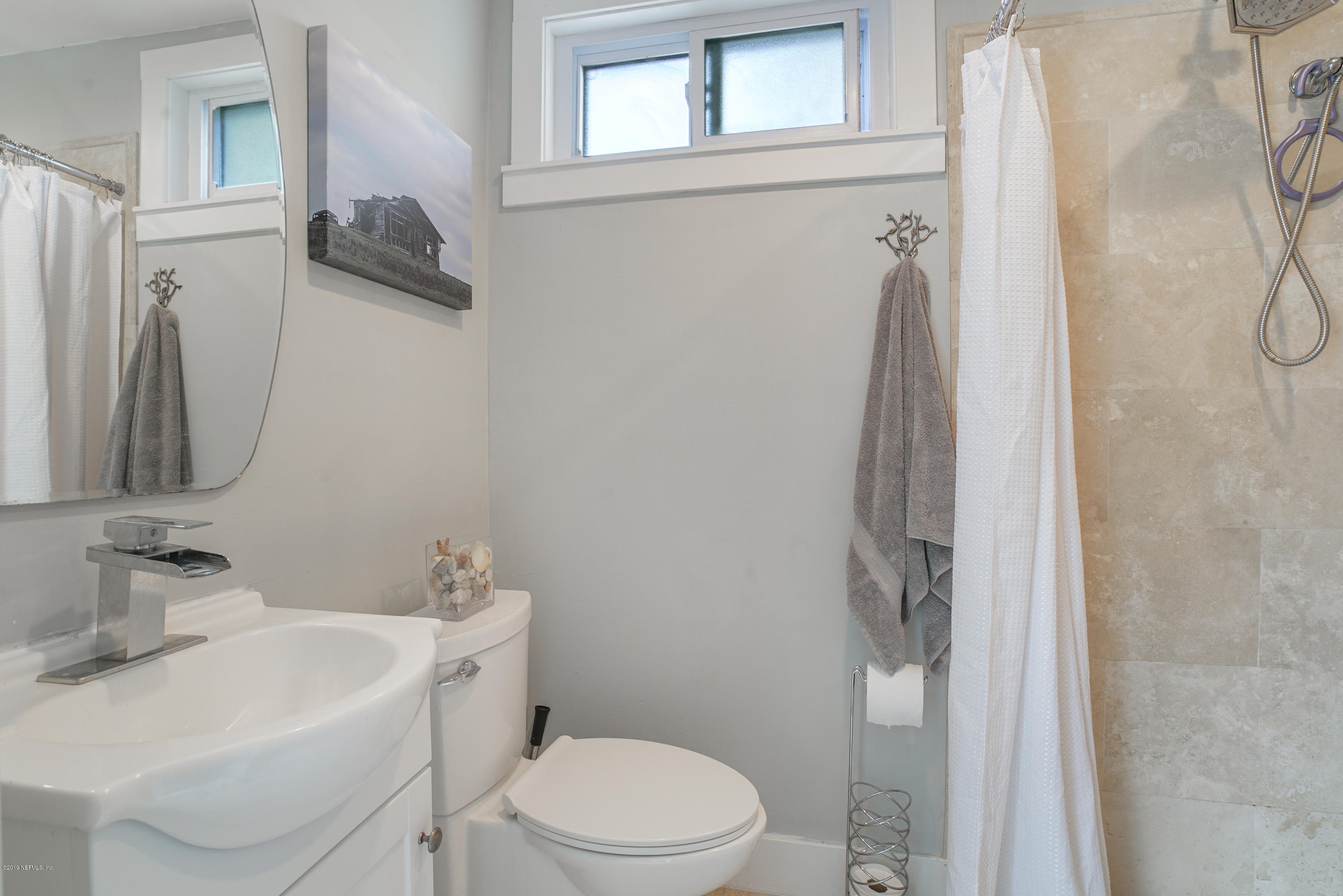 32 Dolphin Drive St. Augustine, FL 32080 - Photo 14 of 43 a bathroom with a sink vanity mirror and toilet