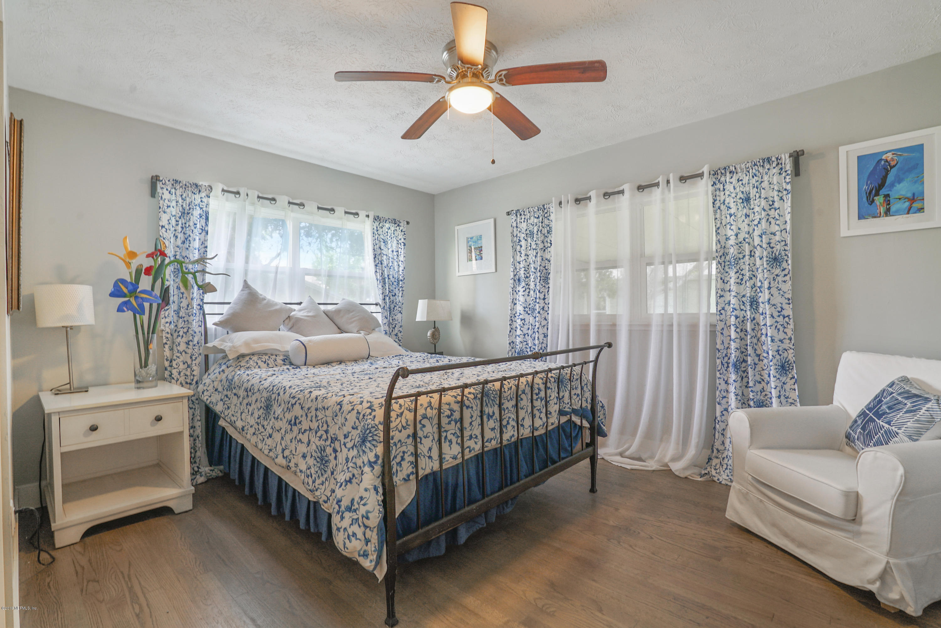 32 Dolphin Drive St. Augustine, FL 32080 - Photo 15 of 43 a bedroom with a bed and a chandelier