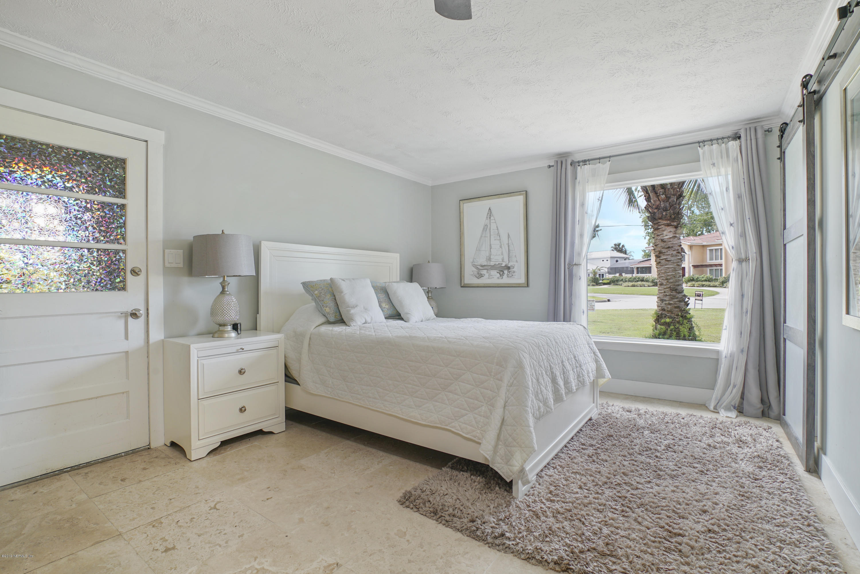 32 Dolphin Drive St. Augustine, FL 32080 - Photo 18 of 43 a spacious bedroom with a bed and a window