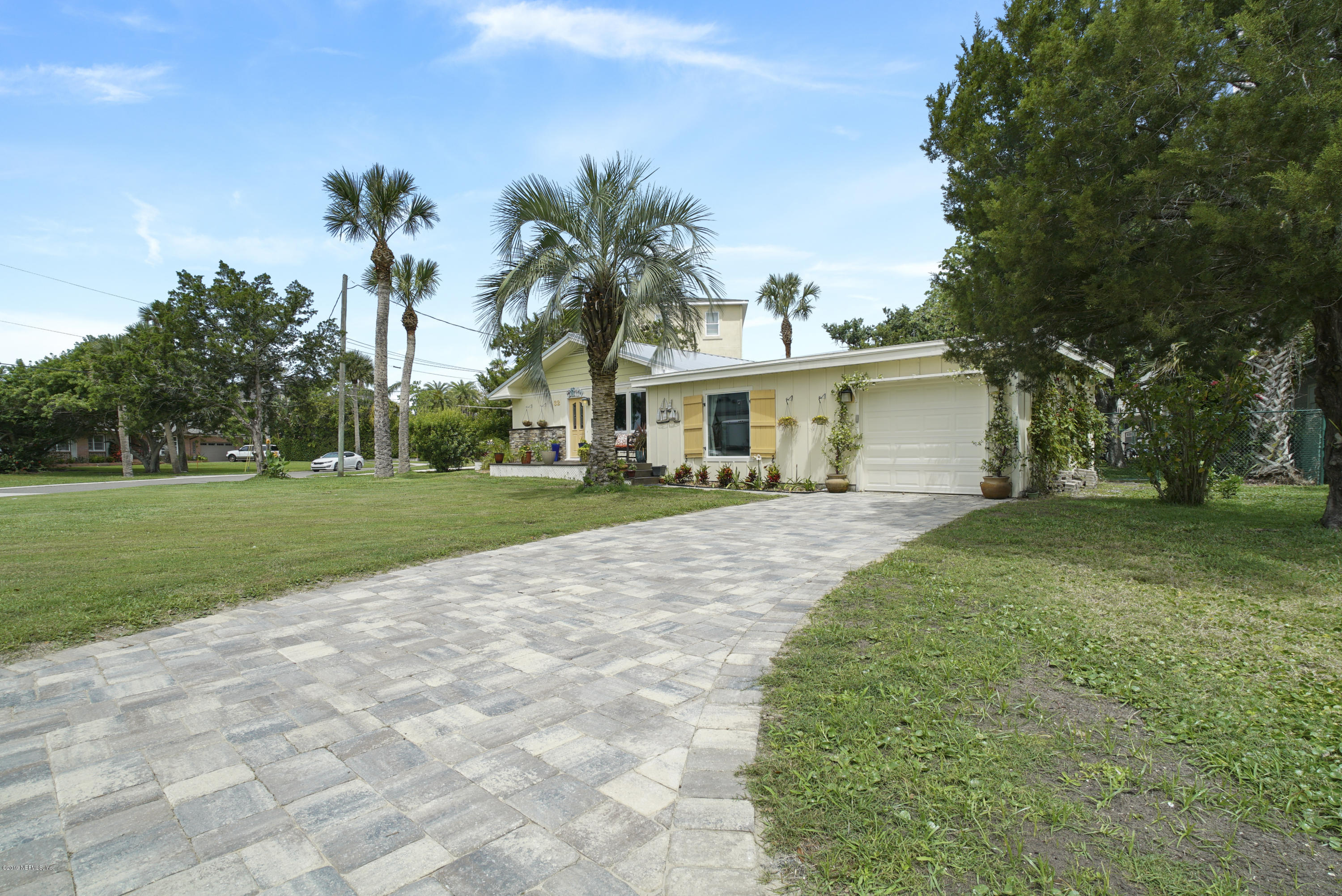 32 Dolphin Drive St. Augustine, FL 32080 - Photo 2 of 43 a front view of a house with a yard and trees