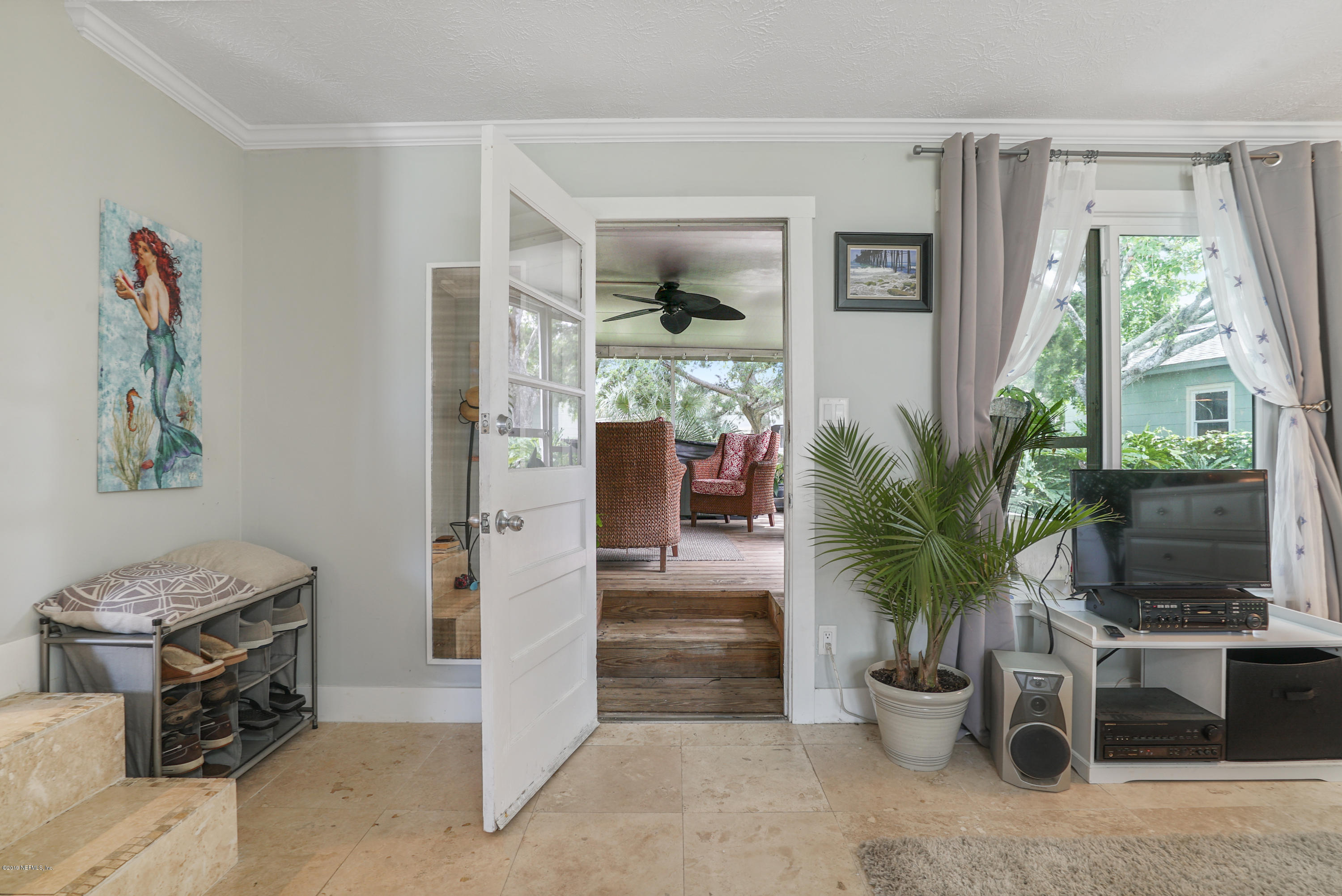 32 Dolphin Drive St. Augustine, FL 32080 - Photo 22 of 43 a living room with furniture potted plant and a window