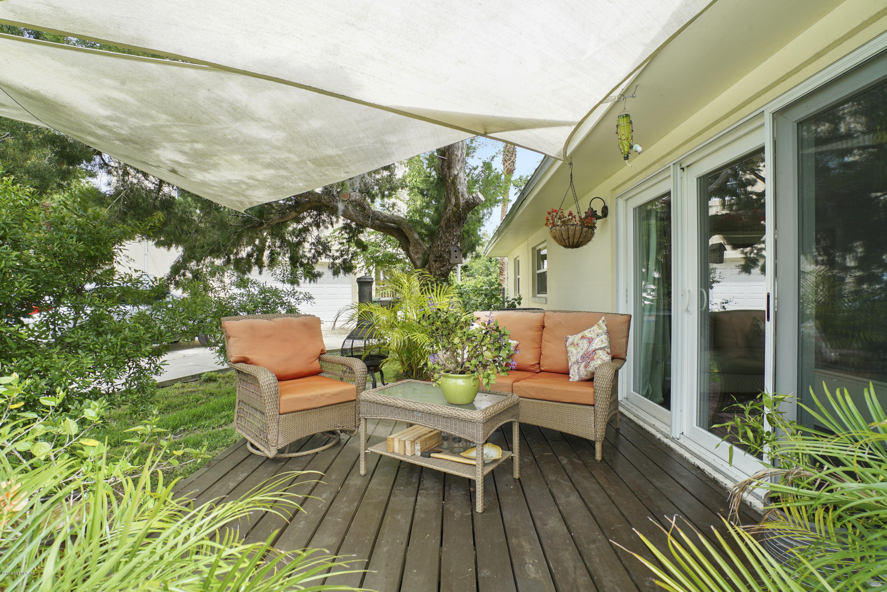 32 Dolphin Drive St. Augustine, FL 32080 - Photo 25 of 43 a balcony with wooden benches and glass door
