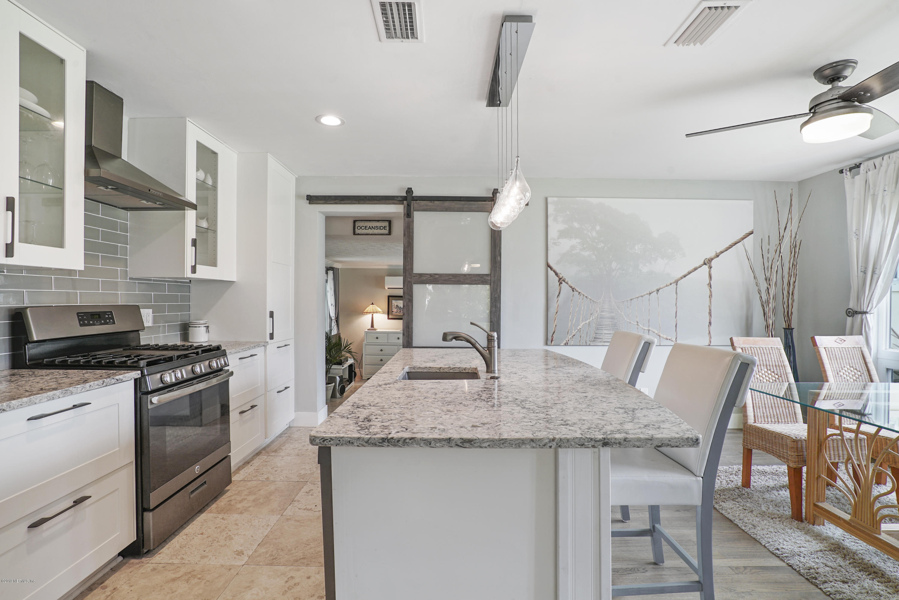 32 Dolphin Drive St. Augustine, FL 32080 - Photo 4 of 43 a kitchen with granite countertop kitchen island stainless steel appliances a stove a sink and a refrigerator